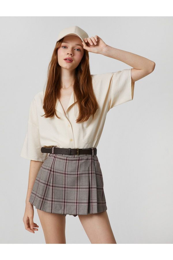 Koton Koton Short-Sleeved Shirt with a relaxed fit, pocket detail and button fastening.
