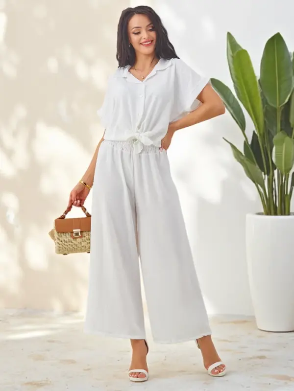 Resti Resti Women's set with a tied short-sleeve shirt and flared pants with rhinestones